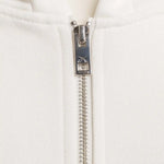 Nahaufnahme des YKK Zwei-Wege-Reißverschlusses mit Squeqo-Logo am Essential Zip Hoodie.